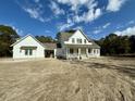 Two-story farmhouse with white siding, gray roof, and a front porch at 3324 Westphal Dr, Johns Island, SC 29455