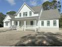 Two-story farmhouse with white siding, gray roof, and a front porch at 3324 Westphal Dr, Johns Island, SC 29455