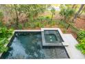 Dark-colored pool and spa with surrounding patio and landscaping at 515 Claret Way, Kiawah Island, SC 29455