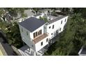 Three-story home with rooftop deck, balconies, and surrounding trees at 615 W Beach Ct, Folly Beach, SC 29439