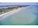 Beachfront aerial view showing ocean, beach, and coastal town at 615 W Beach Ct, Folly Beach, SC 29439