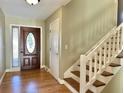 Entryway with hardwood floors, wooden staircase, and stained glass door at 8025 Eberly Ave, North Charleston, SC 29420