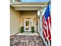 Front door entrance with brick steps and potted plants at 8025 Eberly Ave, North Charleston, SC 29420