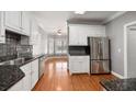 Eat-in kitchen with white cabinets, granite counters, and stainless steel appliances at 8604 Fox Hollow Rd, North Charleston, SC 29420