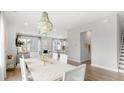 Bright dining room with a white chevron table and an elegant chandelier at 142 Maritime Way, Summerville, SC 29485