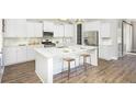 Spacious kitchen with white cabinets, island, and hardwood floors at 1443 Clay Field Trl, Summerville, SC 29485