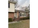 Brick ranch house with a covered entryway, landscaping, and multiple windows at 1972 Green Park Ave, Charleston, SC 29414
