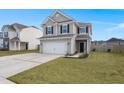 Two-story house with gray siding, white garage door, and a landscaped lawn at 230 Wathen Dr, Goose Creek, SC 29445