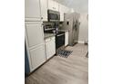 Kitchen boasts white cabinets, granite countertops, and stainless steel appliances at 319 Bradley Bend Dr, Moncks Corner, SC 29461