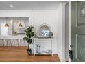 Bright and airy entryway with white wainscoting, a large mirror, and a view into the kitchen at 5259 Hartford Cir, North Charleston, SC 29405