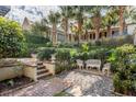 Landscaped backyard oasis with patio, seating area, and lush greenery at 99 Tradd St, Charleston, SC 29401