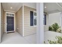 Covered front porch with white columns and a dark-colored front door at 9991 Winged Elm St, Ladson, SC 29456
