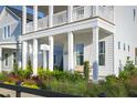 Charming two-story home with a porch swing and landscaping at 1073 Keeper Ln, Summerville, SC 29485