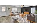 Living room with gray sofas, a large TV, and a wood accent wall at 114 Avalon Rd, Summerville, SC 29483