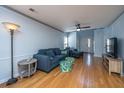 Living room with hardwood floors, blue sectional sofa, and a ceiling fan at 1295 Island Club Dr # E, Charleston, SC 29492