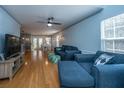 Open living room with hardwood floors, a sectional sofa, and a view of the dining area at 1295 Island Club Dr # E, Charleston, SC 29492