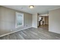 Bright living room with grey wood-look floors and kitchen view at 1984 Hugo Ave, North Charleston, SC 29405