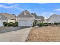 House exterior featuring a two-car garage and manicured lawn at 199 Schooner Bend Ave, Summerville, SC 29486