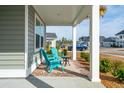 Front porch with teal chairs and a small table at 230 Granton Edge Ln, Summerville, SC 29486