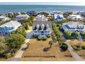 Aerial view of beach neighborhood, showcasing a gray house in the center at 3019 Brownell Ave, Sullivans Island, SC 29482
