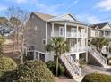 Two-story home with light gray siding, white trim, and a double-door entrance at 3038 Fraserburgh Way # 2200, Mount Pleasant, SC 29466