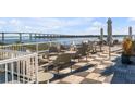 Rooftop deck with water views, comfortable seating, and umbrellas at 310 Longshore St # 645, Daniel Island, SC 29492