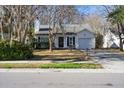 White house with a black front door and a landscaped yard at 359 Muirfield Pkwy, Charleston, SC 29414