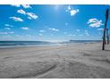 Sandy beach with ocean and blue sky at 367 Pelican Flight Dr, Dewees Island, SC 29451