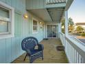 Upper-level porch with wicker chair and sliding glass door access at 403 W West Ashley Ave, Folly Beach, SC 29439