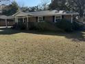 Brick ranch house with a spacious yard and mature trees at 4765 S Constellation Dr, North Charleston, SC 29418