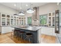 Spacious kitchen with island, stainless steel appliances, and white cabinets at 4991 Timber Race Crse, Hollywood, SC 29449