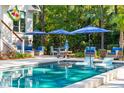 Inviting pool area with patio furniture and umbrellas at 4991 Timber Race Crse, Hollywood, SC 29449