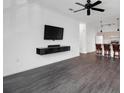 Spacious living room with dark hardwood floors and a mounted TV at 500 Bucksley Ln # 205, Charleston, SC 29492