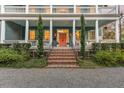 Charming home with brick steps leading to a bright coral front door at 66 Warren St # Entire Property, Charleston, SC 29403