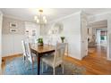 Bright dining room with hardwood floors, white wainscoting, and a wooden table at 947 Night Heron Dr, Mount Pleasant, SC 29464