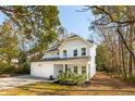 Two-story light blue house with white garage and landscaping at 1216 Ashley Hall Rd, Charleston, SC 29407