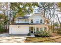 Two-story light blue house with white garage and landscaping at 1216 Ashley Hall Rd, Charleston, SC 29407