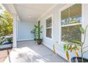 Front porch with light blue siding, potted plants, and white columns at 1216 Ashley Hall Rd, Charleston, SC 29407
