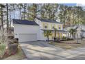 White house with yellow shutters, palm trees, and a long driveway at 125 Trickle Dr, Summerville, SC 29483