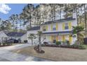 Two-story white house with yellow shutters and American flag at 125 Trickle Dr, Summerville, SC 29483