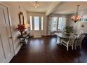 Open dining room and entryway with hardwood floors, and white chairs at 1277 Pearwood Ct, Mount Pleasant, SC 29466