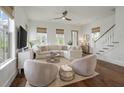 Bright living room featuring a sectional sofa, ceiling fan, and hardwood floors at 1474 Mizzen Aly, Johns Island, SC 29455