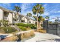 Condo building with tennis courts and lush landscaping in a tropical setting at 1625 Live Oak Park, Seabrook Island, SC 29455