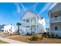 Two-story white house with a front porch and palm tree at 1680 Banning St, Mount Pleasant, SC 29466