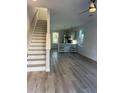 Open living room and kitchen with stairs, hardwood floors, and modern lighting at 2023 Comstock Ave, North Charleston, SC 29405