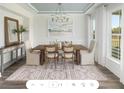 Formal dining room featuring a wood table and large windows at 2082 Cousteau Ct, Johns Island, SC 29455