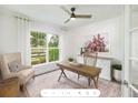 Home office with wood desk, comfortable chair, and large windows at 2082 Cousteau Ct, Johns Island, SC 29455