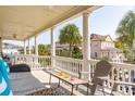 Relaxing porch with wicker seating, offering scenic city views at 212 Calhoun, Charleston, SC 29401