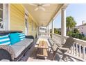 Spacious porch with wicker seating and city views at 212 Calhoun, Charleston, SC 29401