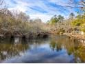 Tranquil lake view with tree reflections in calm water at 218 Cat Hole Ln, Branchville, SC 29432